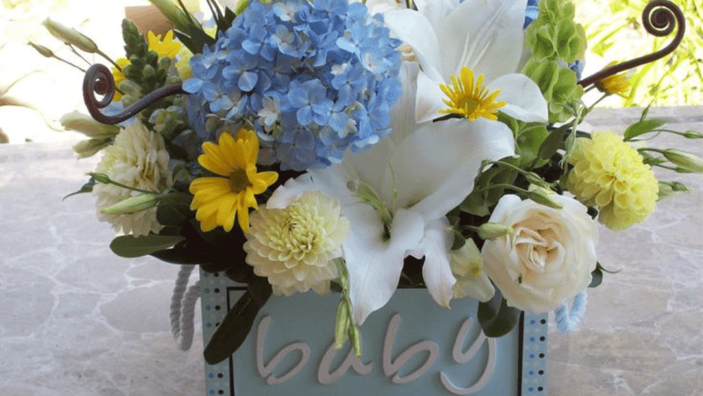 Blue carnation arrangements at a baby shower celebration