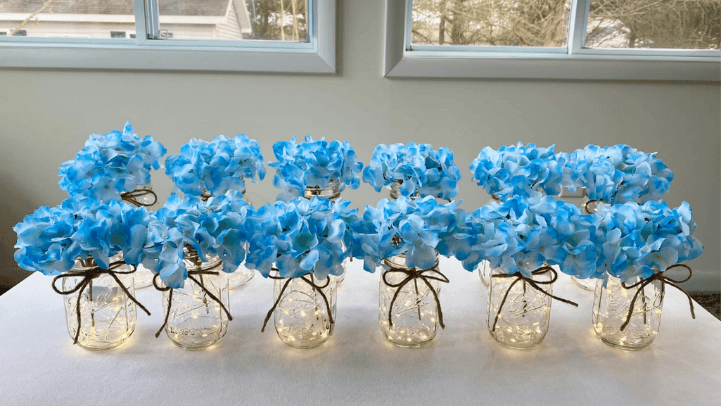 Blue carnations arranged as centerpieces at a wedding reception