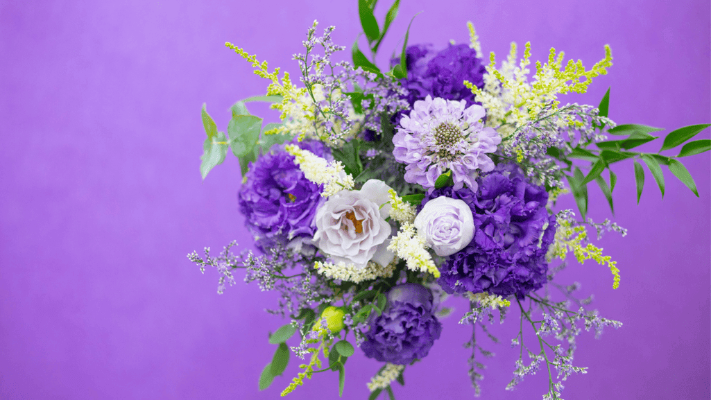 Bridal bouquet featuring blue carnations with white roses